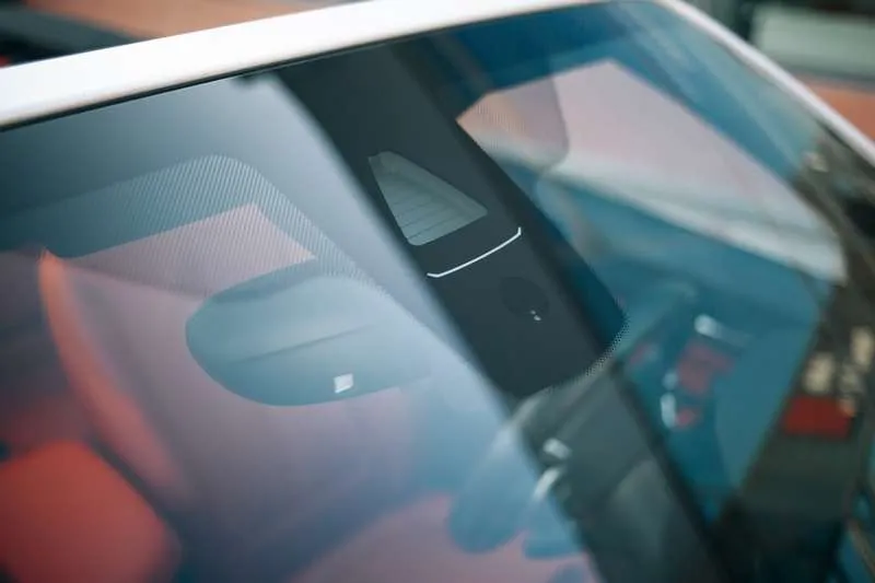 Modern car dashboard behind windshield, technology focus.